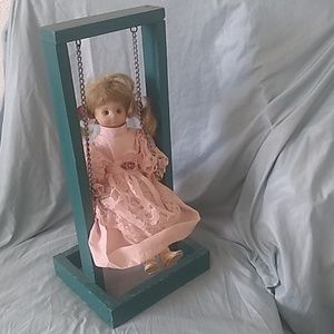 Pig-Tailed Doll on Wooden Swing